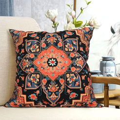 short-pile plush polyester pillow cover with rust floral medallion on black, shown on a cream sofa