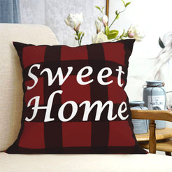 short-pile plush polyester pillow cover with Sweet Home lettering on red buffalo plaid, shown on a cream sofa