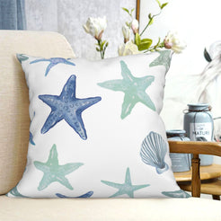 short-pile plush polyester pillow cover with blue and green starfish and shells, shown on a cream sofa