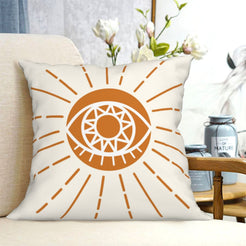 short-pile plush polyester pillow cover with orange circular sun motif on white, shown on a cream sofa
