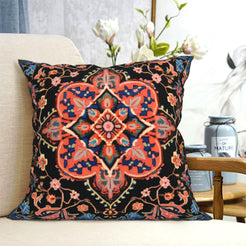 short-pile plush polyester pillow cover with coral geometric medallion on navy, shown on a cream sofa
