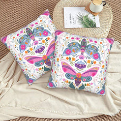 Folk butterfly velvet pillow covers with white folk butterfly medallions, styled on a woven chair