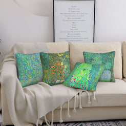 Four green landscape art pillow covers styled on a sofa