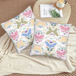 Folk butterfly velvet pillow covers with pastel butterfly silhouettes and flowers, styled on a woven chair