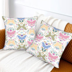 Folk butterfly velvet pillow covers with pastel butterfly silhouettes and flowers, styled on a sofa