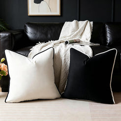 Velvet pillow covers with black and white velvet with contrast piping, styled on a black sofa