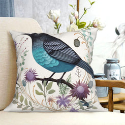short-pile plush polyester pillow cover with teal and black bird among purple flowers, shown on a cream sofa