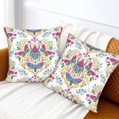 Folk butterfly velvet pillow covers with white folk beetle and butterfly motifs, styled on a sofa