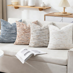 chenille-textured polyester pillow covers with blue, rust, beige and cream stripes, displayed across a cream sofa