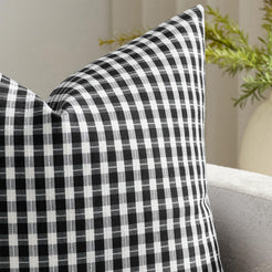 Close-up of woven print and piping on water-resistant linen-look polyester pillow cover with black and white gingham