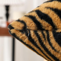 Close-up of hidden zipper and long-pile texture on faux-fur plush polyester pillow cover with golden tiger stripes