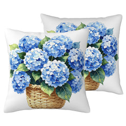 Set of two outdoor water-resistant linen-look polyester pillow covers with blue hydrangeas in a basket