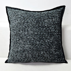 Chenille-textured polyester pillow cover with charcoal chenille texture with black edged trim, shown on white