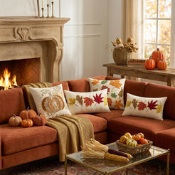 Embroidered polyester canvas pillow covers with autumn pillow designs, styled around a rust sofa