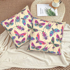 Folk butterfly velvet pillow covers with beige scattered butterflies and beetles, styled on a woven chair