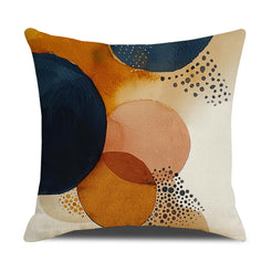 Linen-look polyester pillow cover with navy and rust watercolor circles with dots, shown on white