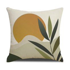 Linen-look polyester pillow cover with mustard sun and dark green botanical shapes, shown on white