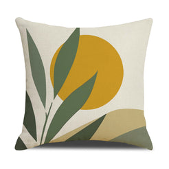 Linen-look polyester pillow cover with mustard sun with large green leaves, shown on white