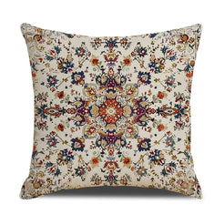 Linen-look polyester pillow cover with rust and blue floral medallion on cream, shown on white