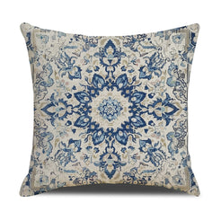 Linen-look polyester pillow cover with blue floral medallion on cream, shown on white