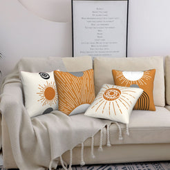 short-pile plush polyester pillow covers with orange sunburst and arch designs, styled on a cream sofa