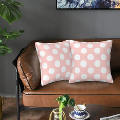 Blush pink polka dot velvet pillow covers styled on a sofa