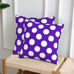 Purple polka dot velvet pillow covers styled on a woven chair