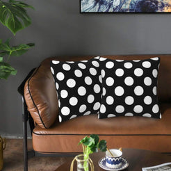 Black polka dot velvet pillow covers styled on a sofa