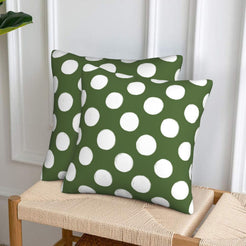 Olive green polka dot velvet pillow covers styled on a woven chair