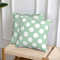 Mint green polka dot velvet pillow covers styled on a woven chair
