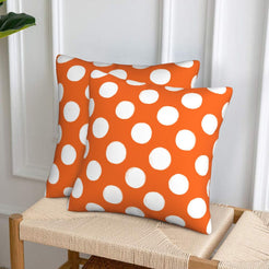 Orange polka dot velvet pillow covers styled on a woven chair