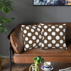 Taupe brown polka dot velvet pillow covers styled on a sofa