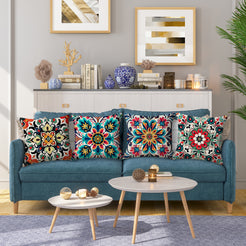 linen-look polyester pillow covers with red, teal and yellow floral medallion prints, styled on a teal sofa