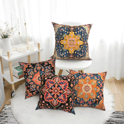 short-pile plush polyester pillow covers with navy, rust and ochre carpet medallion prints, arranged beside a white chair