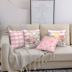 Pink Easter pillow covers with bunnies, plaid, dots and eggs, styled on a sofa