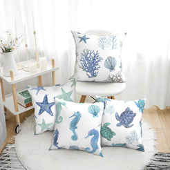 short-pile plush polyester pillow covers with blue and green coastal sea-life prints, arranged beside a white chair