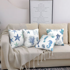 short-pile plush polyester pillow covers with blue and green coastal sea-life prints, styled on a cream sofa