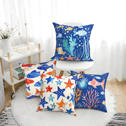 short-pile plush polyester pillow covers with colorful fish, coral and starfish prints, arranged beside a white chair