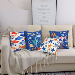 short-pile plush polyester pillow covers with colorful fish, coral and starfish prints, styled on a cream sofa