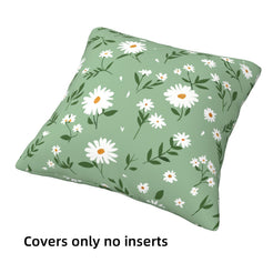 short-pile plush polyester pillow cover with white daisies and leafy sprigs on green, shown at an angle on white