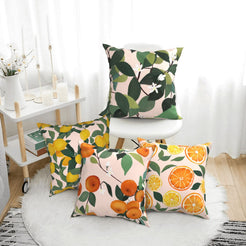 Summer short-pile plush pillow covers with citrus fruit and leafy patterns, styled in a bright room