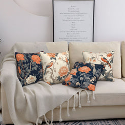 Short-pile plush pillow covers with peonies, cranes and branches in cream and navy, styled on a cream sofa