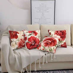 Short-pile plush pillow covers with large red chinoiserie flowers, styled on a cream sofa