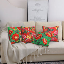 Short-pile plush pillow covers with bright red flowers on green, styled on a cream sofa