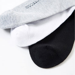 Close-up of black, white and gray silver-fiber cotton-blend sock toes