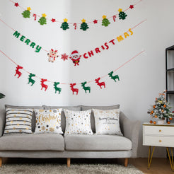 short-pile plush polyester pillow covers with black and gold Christmas prints, styled on a gray sofa beneath holiday garlands