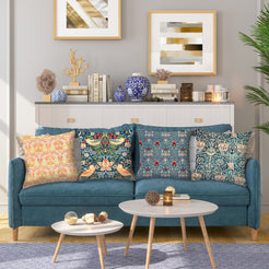 Short-pile plush polyester pillow covers with ornate floral and bird prints, styled on a teal sofa