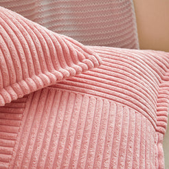 Close-up of pink patchwork corduroy ribs and seams