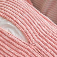 Pink corduroy pillow cover opened to show the smooth inner lining