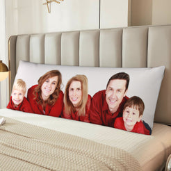 Custom family photo body pillow cover styled across a bed